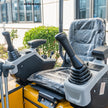 Ergonomic operator seat with dual pilot hydraulic control joysticks on Hengwang HW-13W 1.3 ton mini excavator
