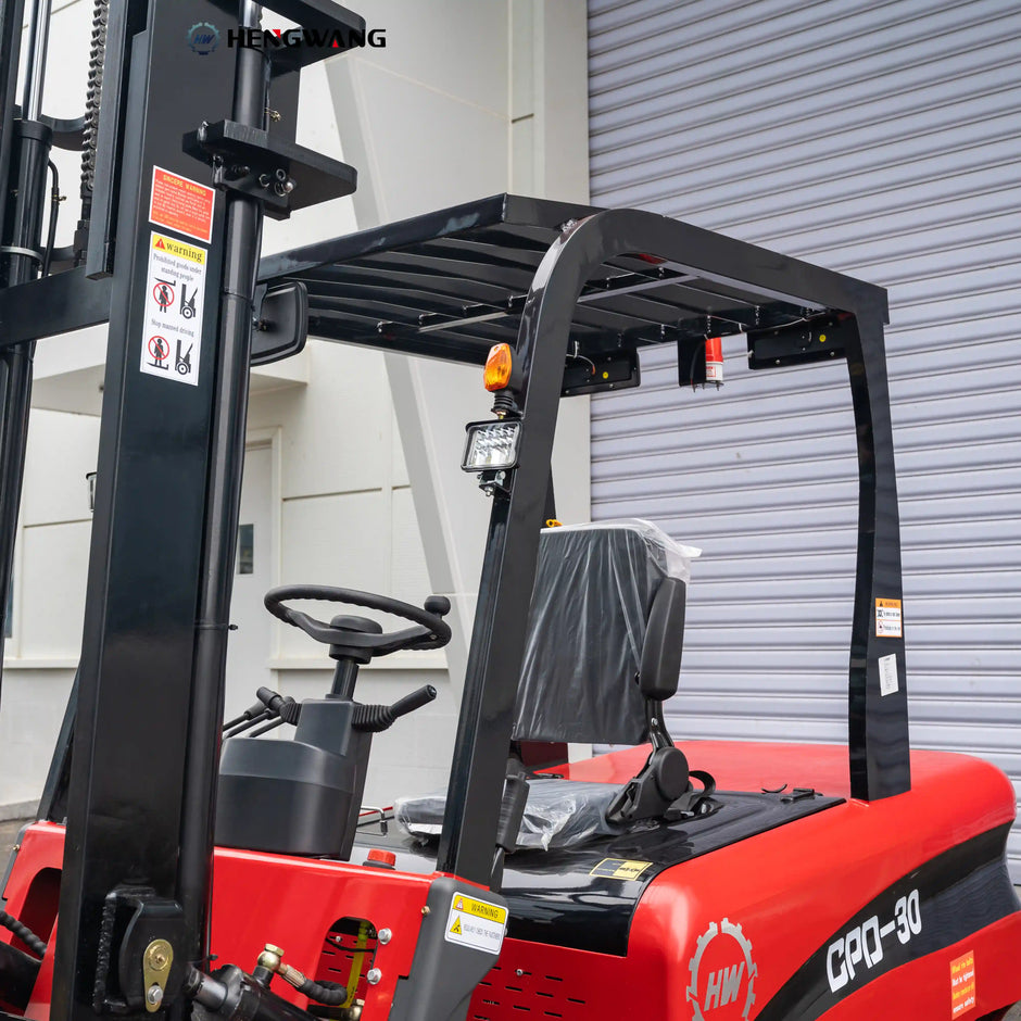 Close-up of the black overhead safety guard on a 6,500 lb 60V electric forklift, showing steel roof frame, amber warning beacon, LED work light, and operator compartment with steering wheel and vinyl seat.
