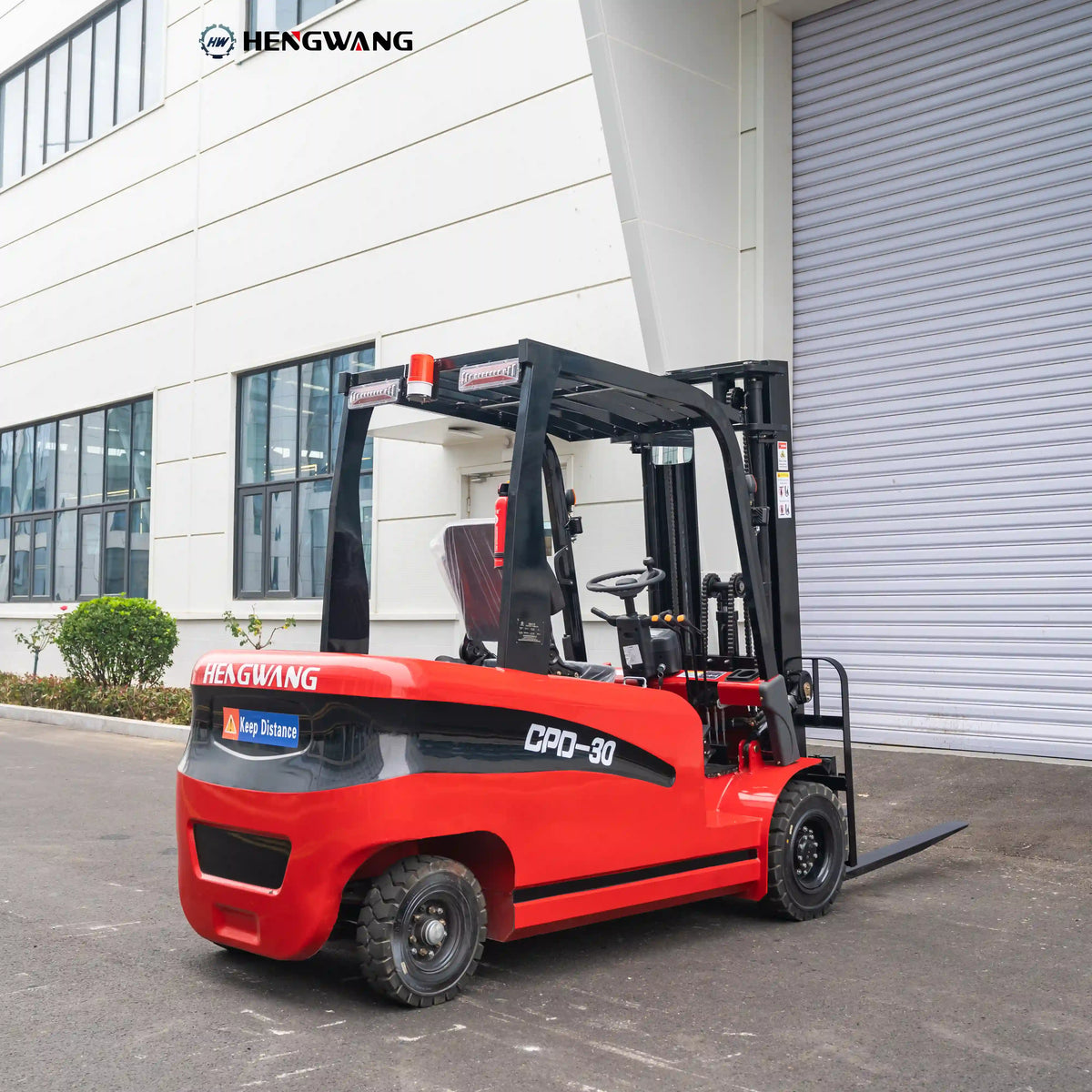 Rear three-quarter view of a 6,500 lb 60V electric forklift showing heavy rear counterweight, overhead guard with amber warning beacon and LED work lights, and deep-tread rubber tires for warehouse operation.