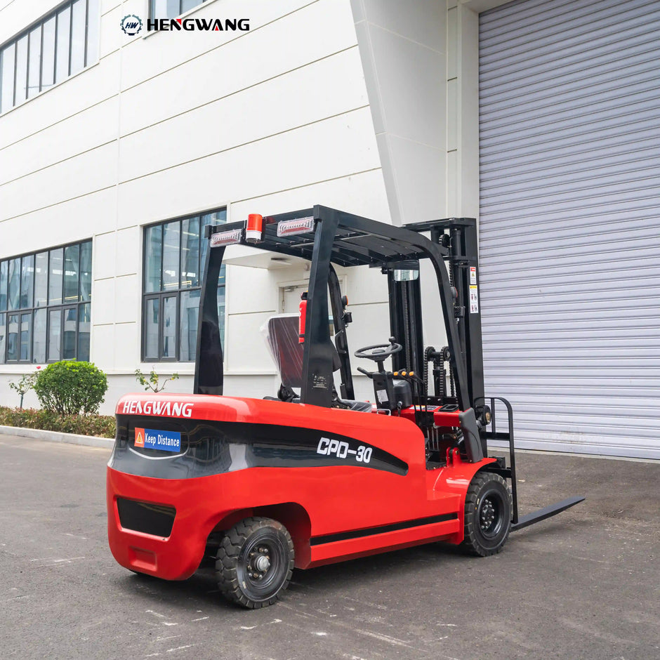 Rear three-quarter view of a 6,500 lb 60V electric forklift showing heavy rear counterweight, overhead guard with amber warning beacon and LED work lights, and deep-tread rubber tires for warehouse operation.