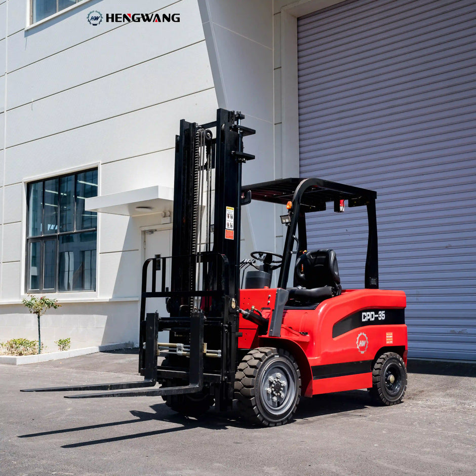 7700 lb electric forklift parked outside an industrial building, left-front view with lowered mast and forks in resting position