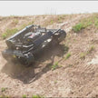 Remote control lawn mower with tracked drive mowing grass on slopes and rough terrain