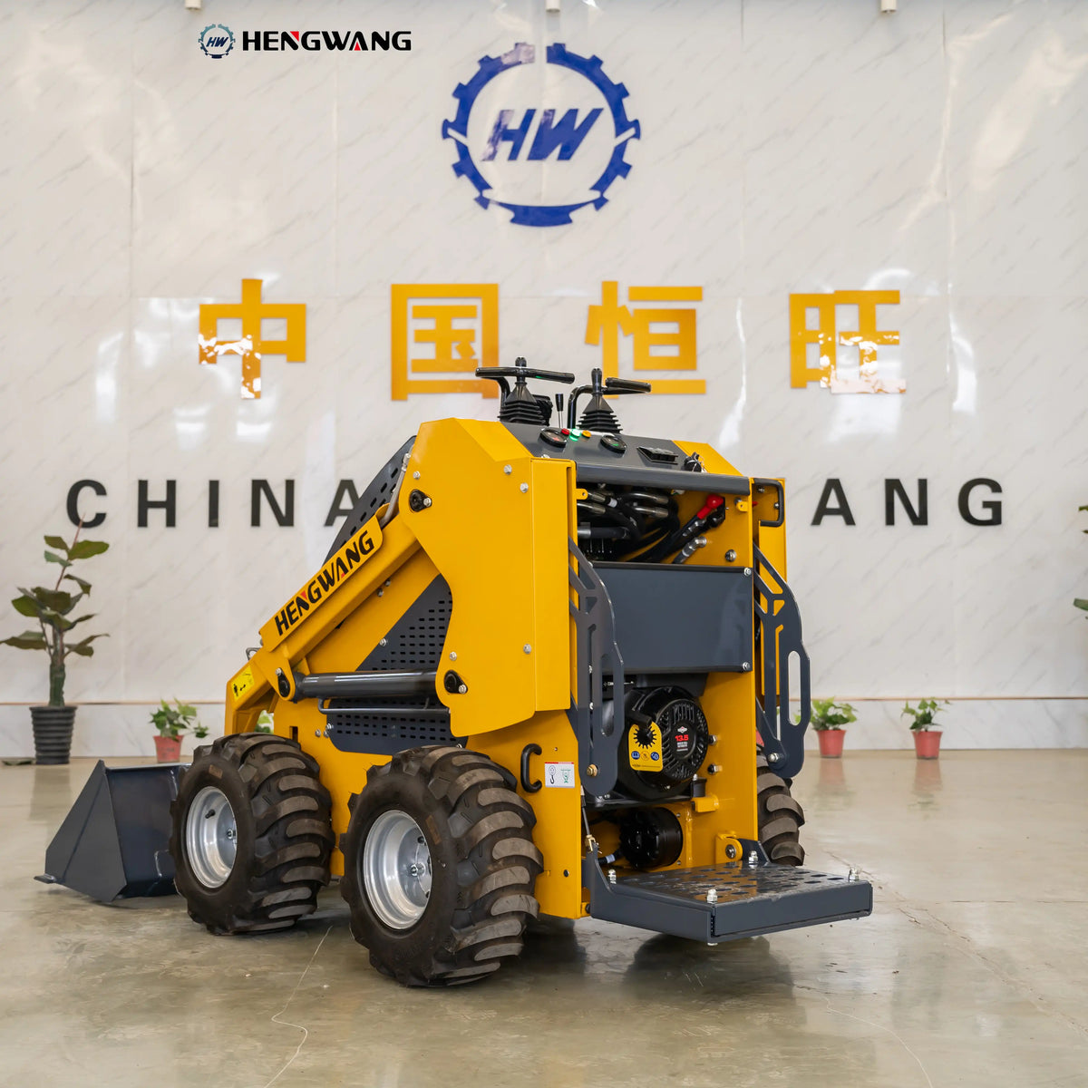 Rear view of the 900 kg skid steer loader with durable engine housing, rear tires and compact frame for stable operation